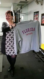 Janine now holding a sweatshirt that shows how far her weight loss has come!
